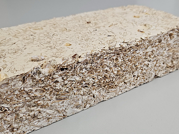 Picture of a small block of the composite material made from straw, husks, and starch.