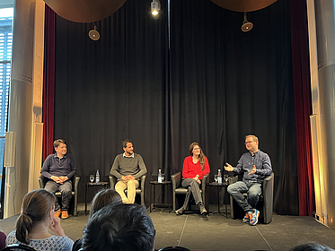 four presenters with auditorium