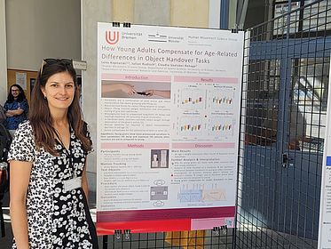 [Translate to English:] Dr. Lena Kopnarski in front of her poster at the Joint Action Meeting X in Turin.