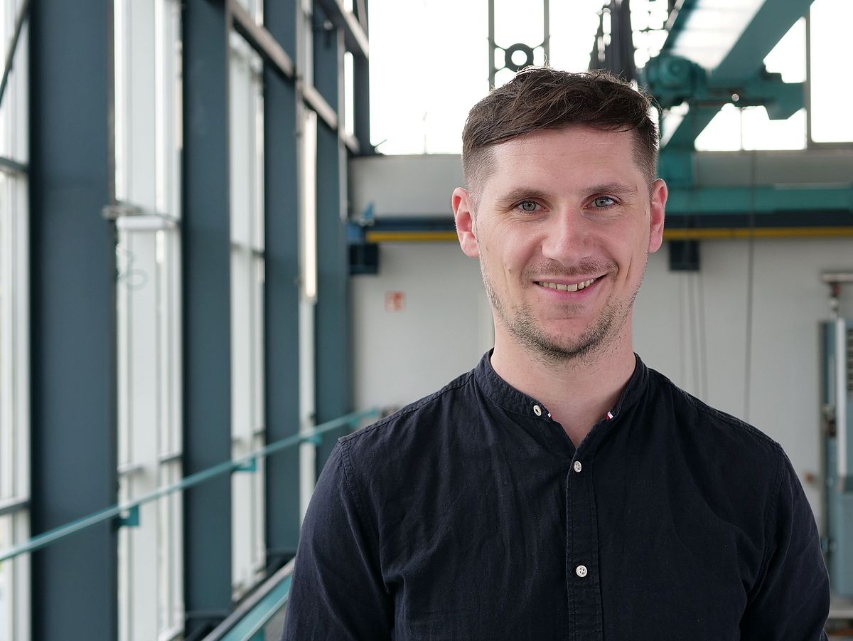 A man is smiling at the camera