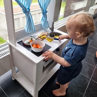 Kind in der Spielzeugküche