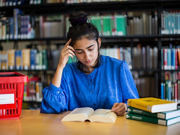 A student reading in the library.