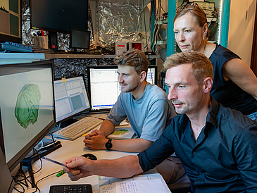 Dr. Eric Drebitz and his team reviewing research findings.