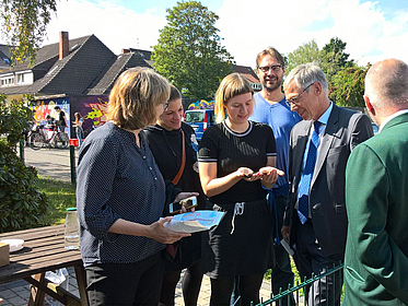 Group of persons looking on a smartphone screen