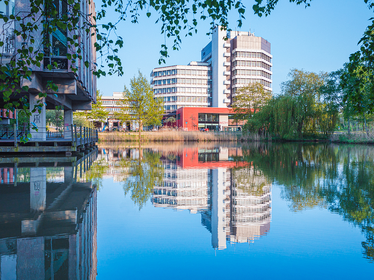 The MZH reflected in a lake in Campus Park.
