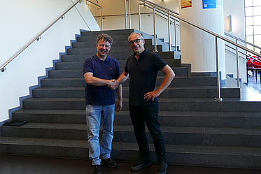 Former Dean Rolf Drechsler (left) congrats new Dean Rainer Malaka