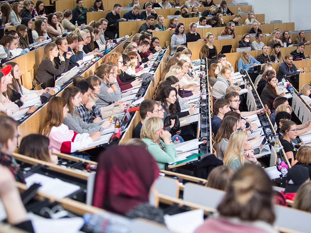 Students Attentive audience in the packed lecture hall.