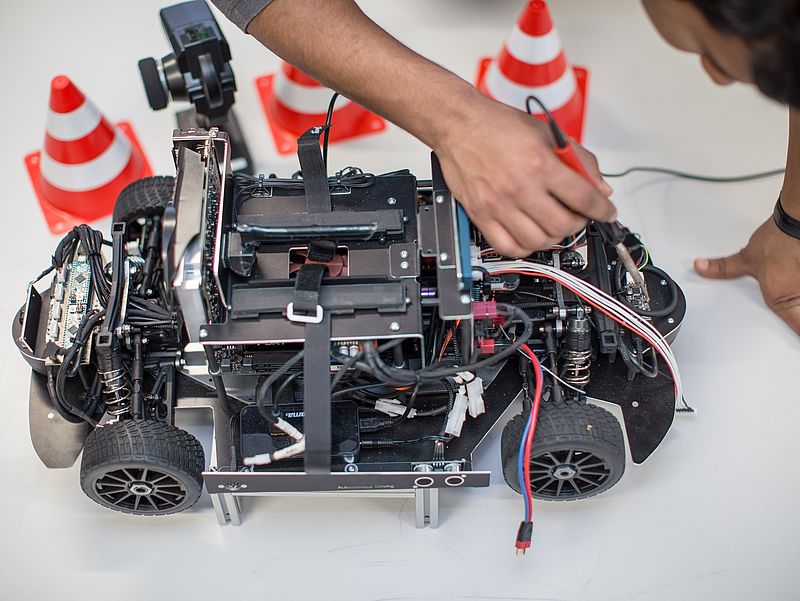 A self-propelled model car on a table.