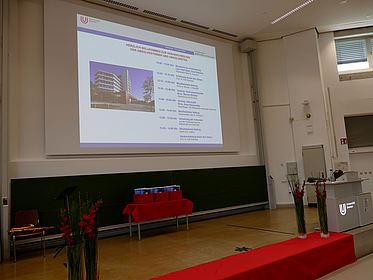 The empty graduation podium and a schedule of the ceremony can be seen