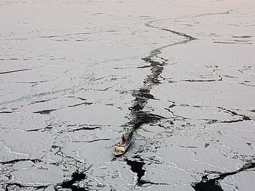 Aerial view of research vessel in ice.