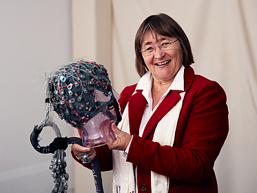 Prof. Tanja Schultz holding an EEG head