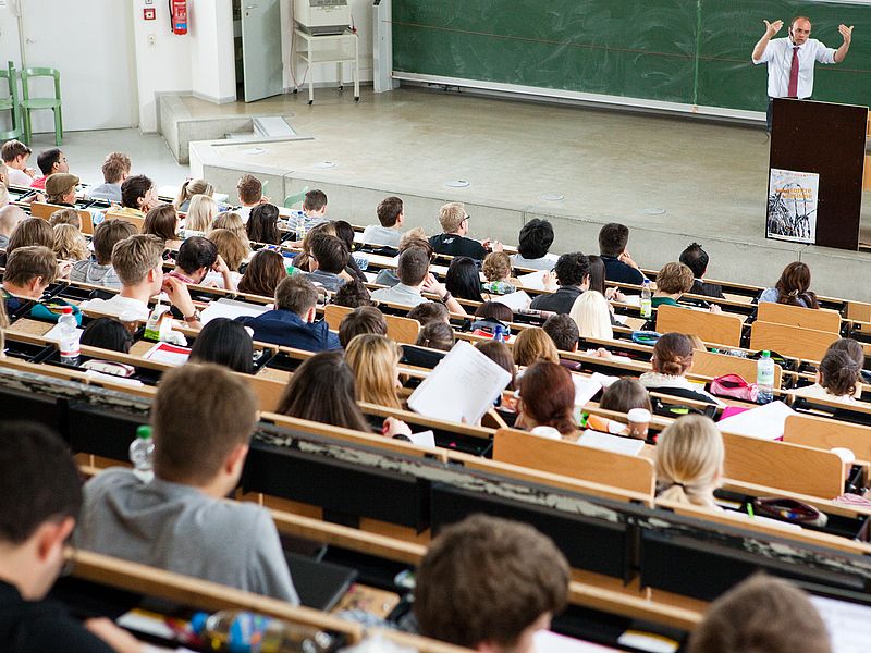 A lecturer in the full lecture hall.