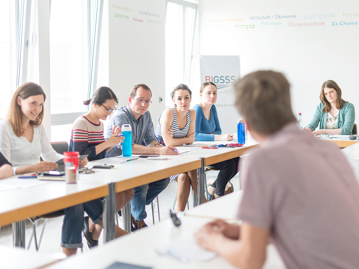 People in conversation in a seminar room.