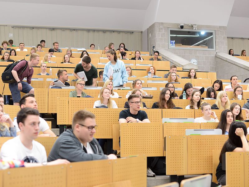 Audience in a crowded lecture hall.