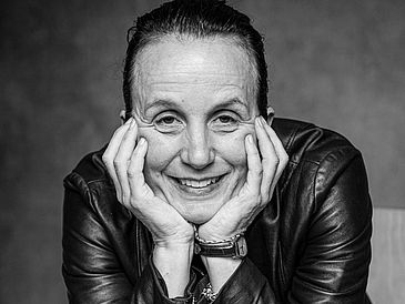 Black-and-white portrait of Sabine Doff in a seated position