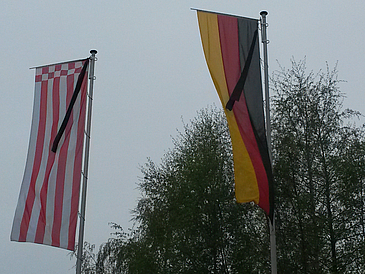 Flags of Bremen and Germany with black ribbon