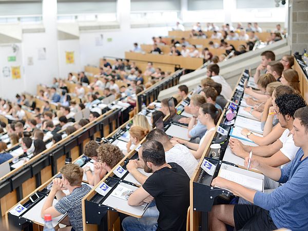 Audience in a crowded lecture hall.