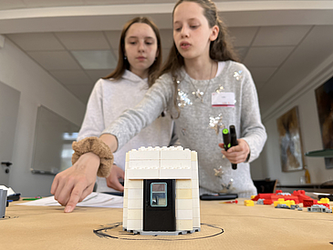 Girls working on their first programmed robots.
