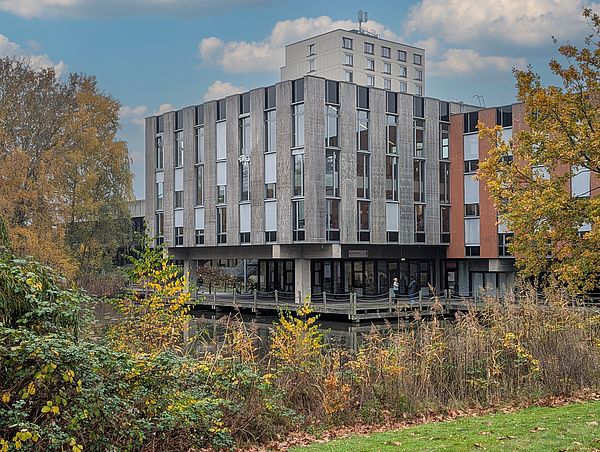 The university dining hall building next to the Mensa lake.