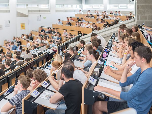 Audience in a crowded lecture hall.
