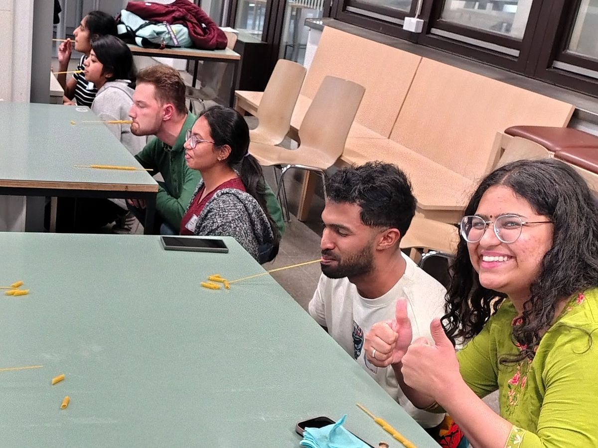 Teams in the competition threading spaghetti onto a cannelloni with their mouths.