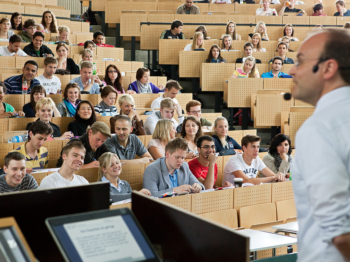A lecturer in the full lecture hall.
