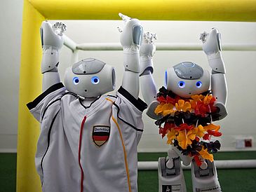 Two football robots cheering.