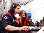 Two female scientists work in front of a computer