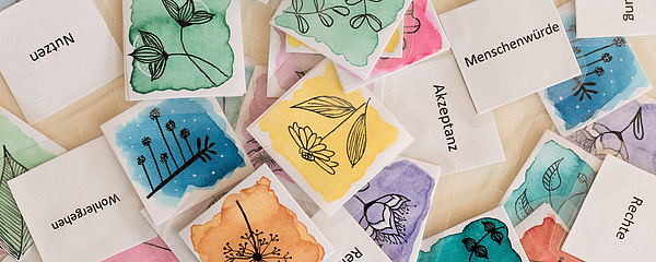 Zu sehen sind bunte Bilder und ethische Begriffe