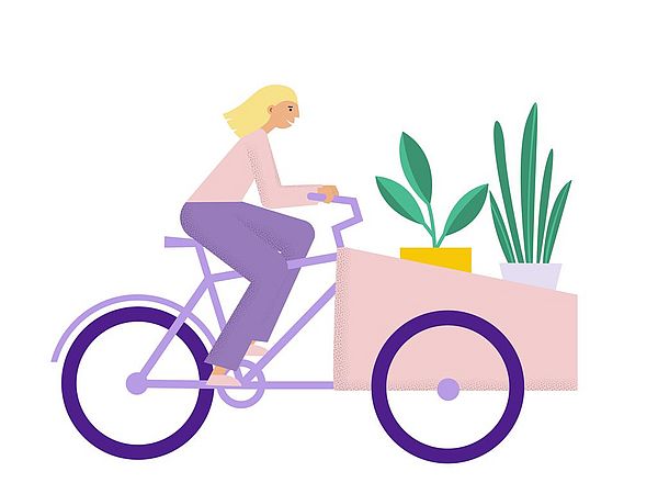 Eine Frau transportiert mit einem Lastenrad Pflanzen.