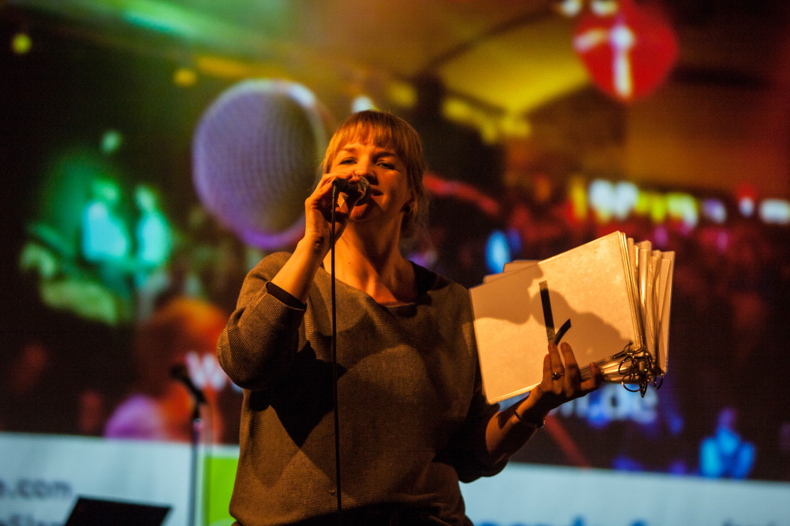 Eine Science Slammerin mit Mikrofon.